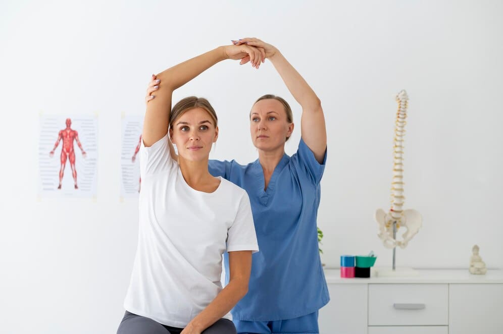 physiotherapist-helping-female-patient-her-clinic_23-2149115564
